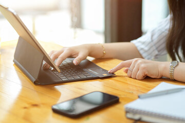 Closeup, Businesswoman paying via online payment on tablet