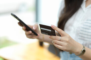Close up, Businesswoman using mobile phone and holding credit card for online payment
