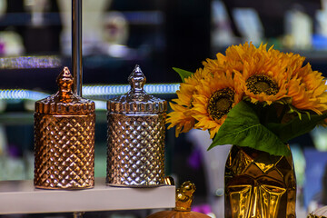 Two decorative vessels of gold and silver colors