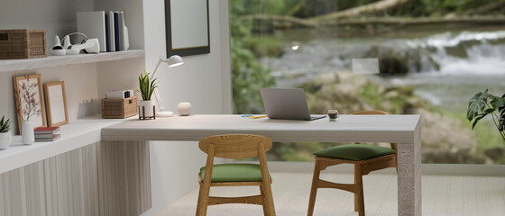 Inspirational workspace in modern living room, laptop computer, blurred natural waterfall view, 3d rendering