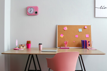 Modern workplace with stationery near light wall