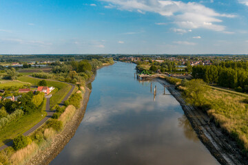 Fototapeta premium Aerial view of the Scheldt river, in Baasrode, Belgium, on a clear sunny day 