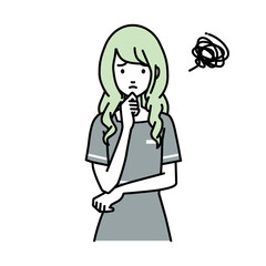 立って手をあごにあてて困っているエステ店員の女性