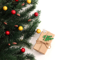 Christmas tree branches and decor on a white isolated background with a place to copy the text. Christmas background.