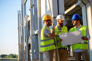 Construction engineers discussion with architects at construction or building site