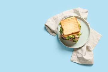 Plate with tasty sandwich on color background