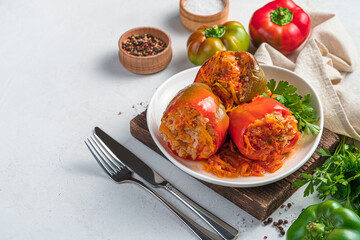 Stewed stuffed pepper with turkey, rice and vegetables on a light background. Healthy food.