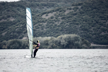 Windsurfer surfing on a windy day at the river.