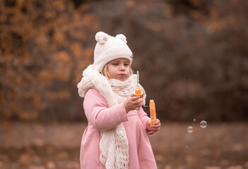Girl, garden, pink coat, soap bubble blower