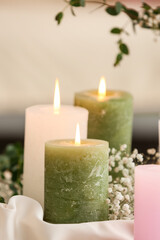 Burning candles and gypsophila flowers, closeup