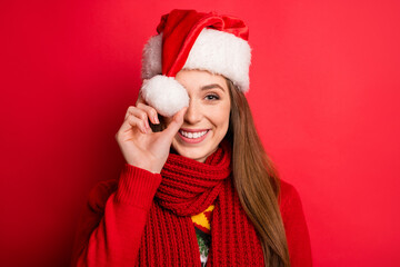 Photo of funny young lady hold cap wear holiday sweater scarf isolated on red color background