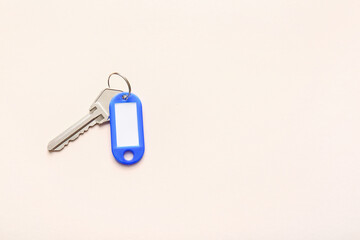 Plastic tag with key on light background