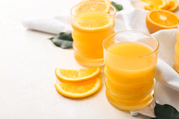 Glasses of tasty orange juice on light background, closeup