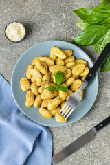 Composition with tasty pesto gnocchi on grey background