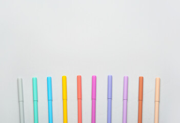 Colorful markers on light background