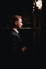 a man in a business suit in a dark room. 