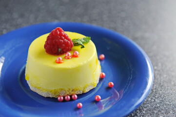 Pudding with raspberries in a plate on the table