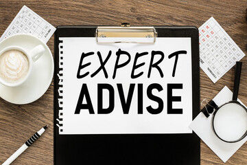 EXPERT ADVICE. text on wood table, on white paper