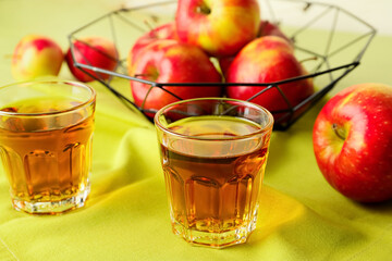 Glasses of tasty apple juice on table, closeup