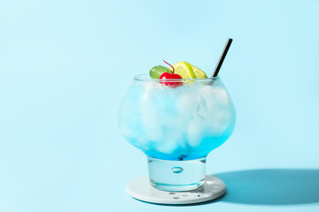 Glass of Blue Lagoon cocktail on color background