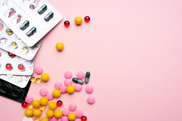 colorful pills packaging vitamins health care pink background