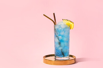 Glass of Blue Lagoon cocktail on color background
