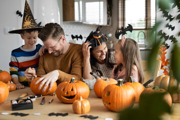 Happy family making jack-o-lantern