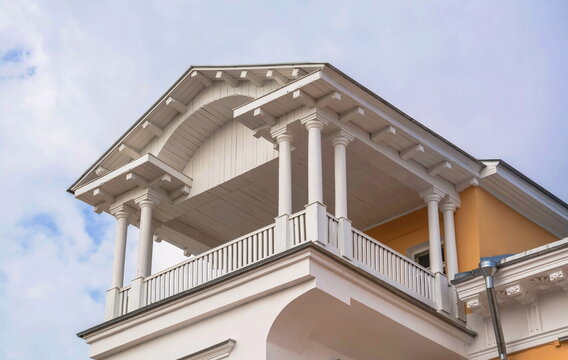 Fragment of an old wooden mansion - a balcony-terrace with columns