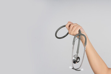 The stethoscope in hand medicine on white background isolation