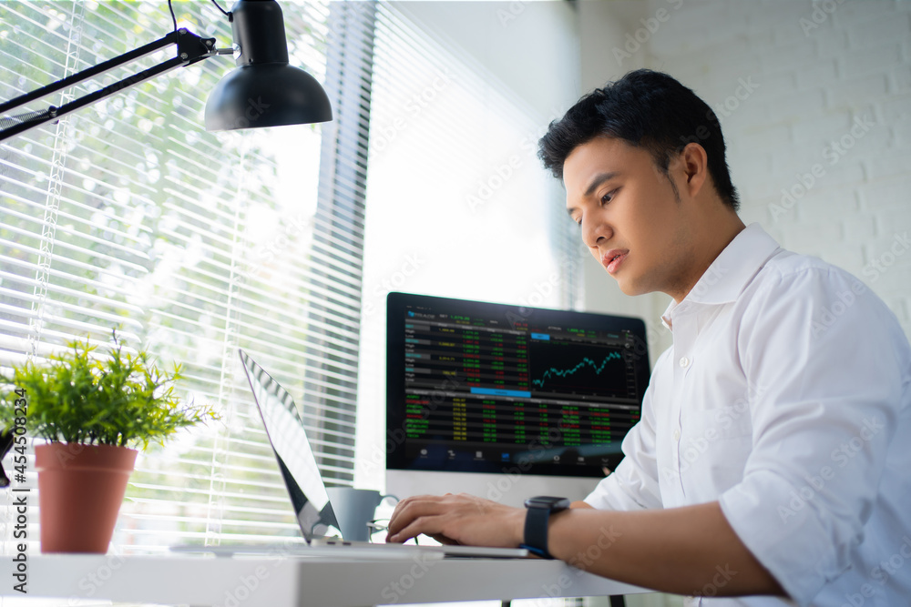 Poster confident businessman. young bearded trader in formal wear is analyzing trading charts on computer s