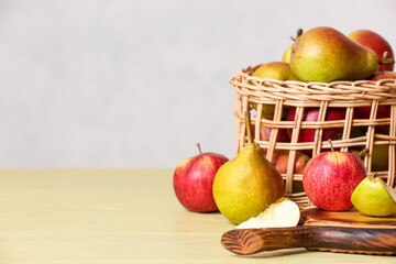 Basket with ripe fruits on table