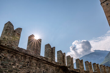 The sun filters through the battlements of Fenis Castle, Aosta Valley, Italy, in the early hours of the new day