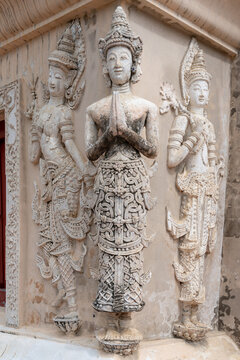 Traditional ancient stucco carving life size deities on wall of hor trai library in Wat Phra Singh buddhist temple, famous landmark of Chiang Mai, Thailand