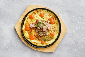 Top view of eggs with bacon and tomato baked in oven
