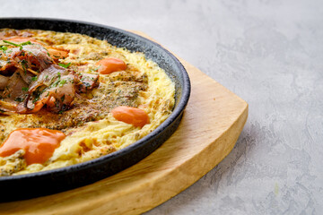 Closeup view of eggs with bell pepper and tomato baked in oven