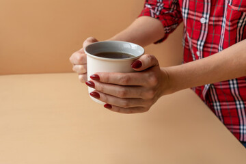 Close up of hands holding cup tea.