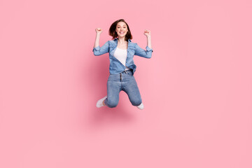 Full length body size photo girl jumping high gesturing like winner overjoyed isolated pastel pink color background