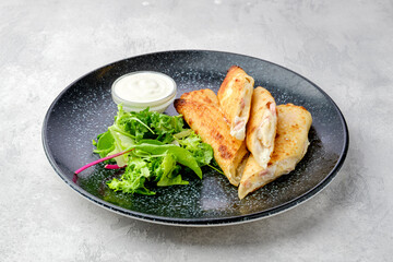 Thin crepe stuffed with melted cheese and ham