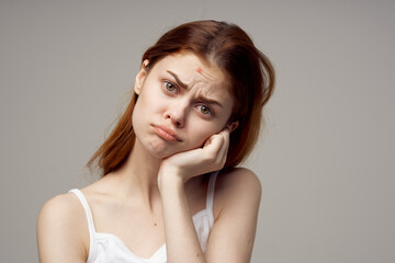 Fototapeta premium red-haired woman facial skin problems dermatology light background