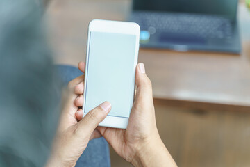 Mockup image of man's hands holding white mobile phone with blank screen in cafe,copy space on smart phone for advertisement.
