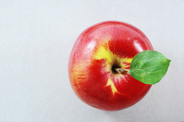 ripe red apple with green leaf