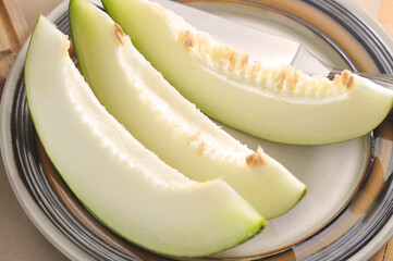 melon slices on a plate and a knife