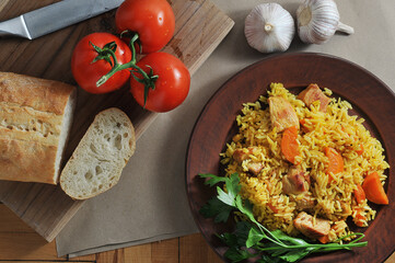 rice pilaf in a plate - a dish with meat, carrots and rice