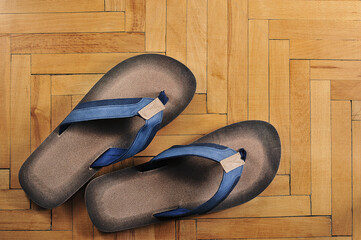 flip-flops on a yellow wooden parquet-top view