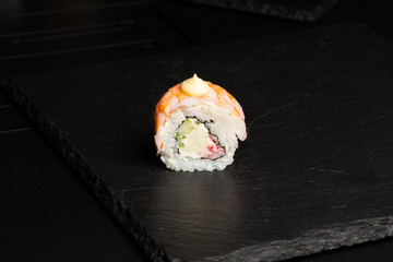 Traditional japanese nigiri sushi, separated on black stone background