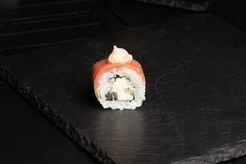 Traditional japanese nigiri sushi, separated on black stone background