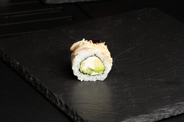 Traditional japanese nigiri sushi, separated on black stone background