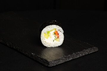 Traditional japanese nigiri sushi, separated on black stone background