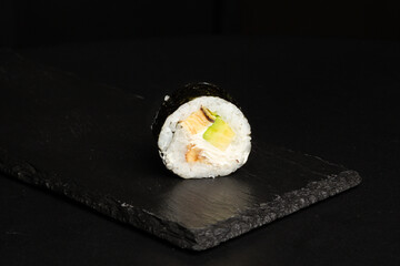 Traditional japanese nigiri sushi, separated on black stone background