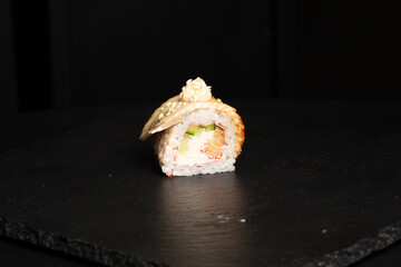 Traditional japanese nigiri sushi, separated on black stone background